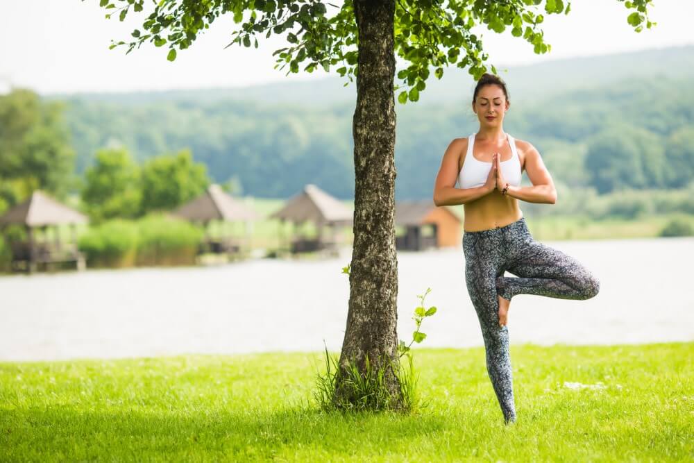 young-fit-woman-doing-yoga-park-near-lak